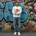 East Asian man wearing a white autism awareness giraffe sweatshirt.