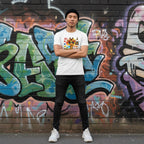 East Asian man wearing a white its ok to be different giraffe tee.
