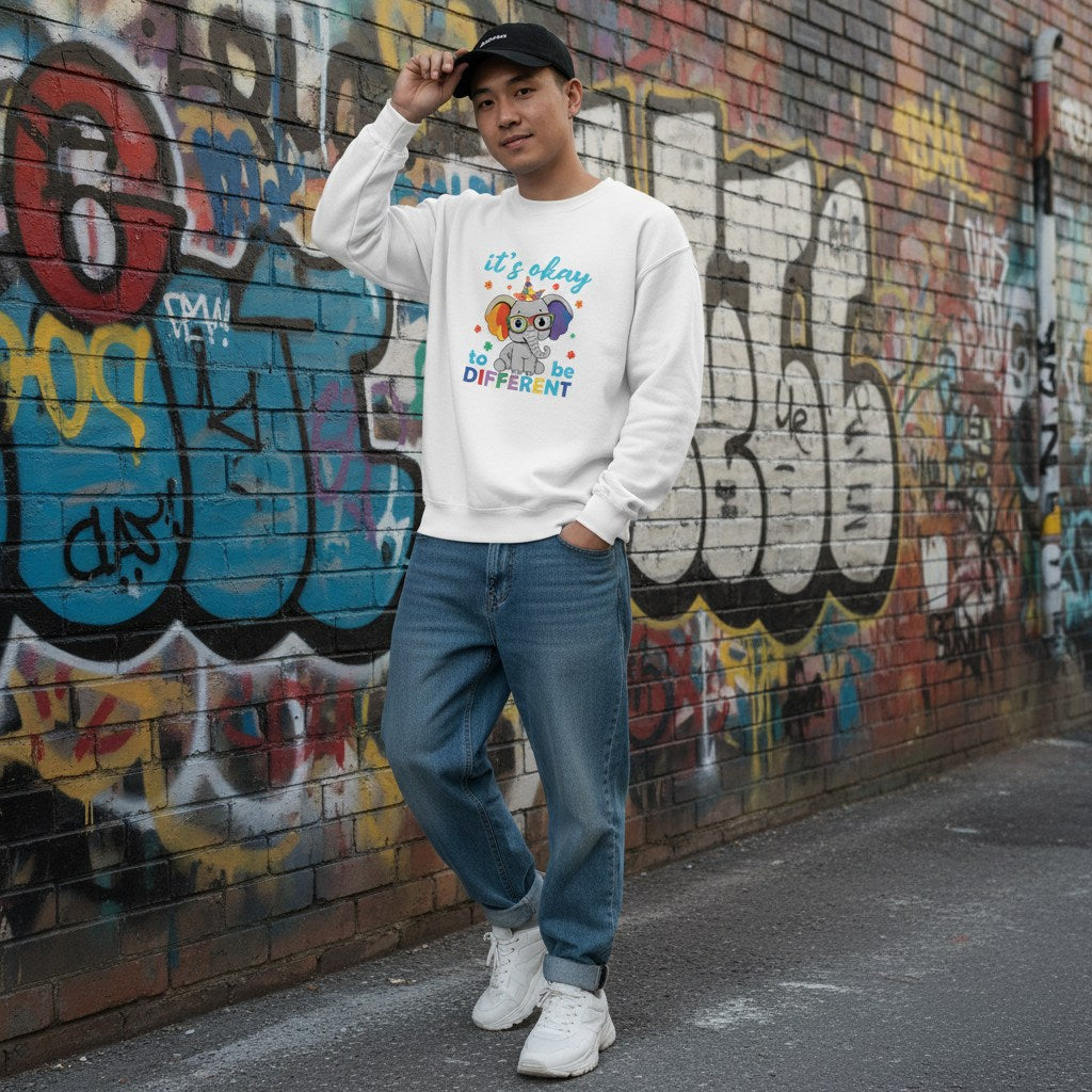 East Asian man wearing a white It's Okay To Be Different autism awareness elephant sweatshirt.