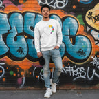 East Asian man wearing a white autism awareness puzzle heart sweatshirt.