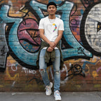 East Asian man wearing a white autism awareness puzzle heart T-shirt in a streetwear style.