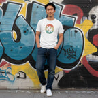 East Asian man wearing a white retro sunset puzzle piece autism awareness T-shirt.