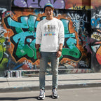 East Asian man wearing a white autism skeleton puzzle sweatshirt.