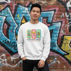 East Asian man wearing a white autism awareness sweatshirt in a streetwear style.