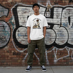 East Asian man in a streetwear style photo wearing a white t-shirt.