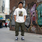 East Asian man wearing streetwear in an urban setting.