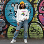 East Asian woman wearing a white be happy in your own shell sweatshirt.