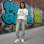 East Asian woman wearing a white God Says I Am autism awareness T-shirt.