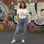 East Asian woman wearing a white I Don't Struggle With Autism I'm Pretty Good At It T-shirt.