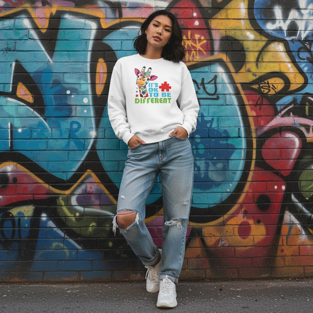 East Asian woman wearing a white It's Okay To Be Different autism giraffe sweatshirt.