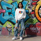 East Asian woman wearing a white puzzle heart sweatshirt.