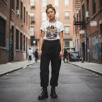 East Asian woman in streetwear attire posing outdoors.
