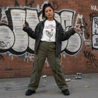 East Asian woman wearing a white streetwear t-shirt outdoors