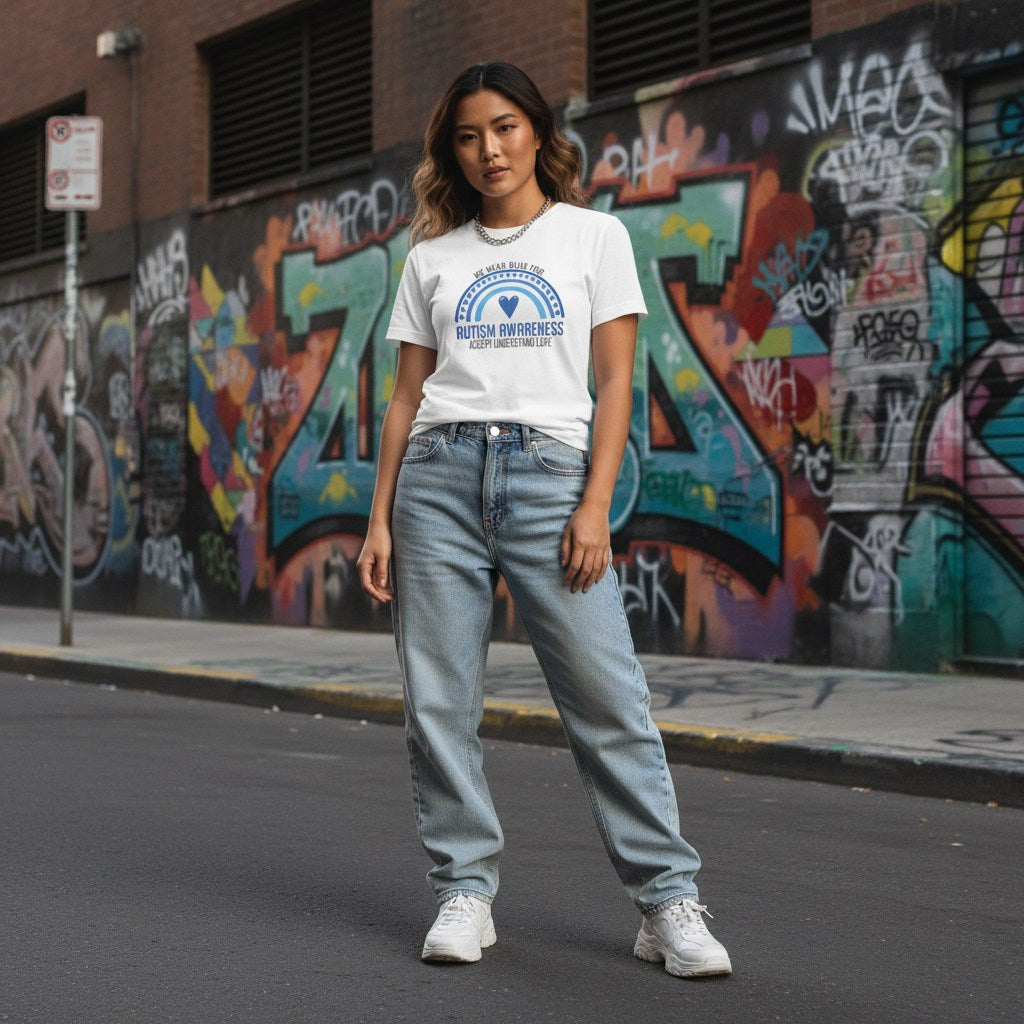 East Asian woman wearing a white autism awareness t-shirt.