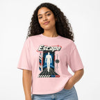 Escape Graphic Unisex Cotton t shirt in Light Pink worn by a studio model in an upper-body three quarter right pose on a clean white background