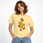 Model wearing a Butter T-shirt featuring a colourful cartoon chicken with wide eyes, wings, orange crest and waddling feet.
