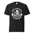 Front view of a Black T-shirt featuring a white Bigfoot among Mountains beneath a Moon, with “HIDE AND SEEK WORLD CHAMPION” text.