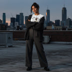 Hispanic woman wearing a white t-shirt in an urban streetwear setting.
