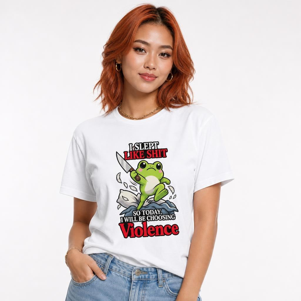 Model wearing a white T-shirt with a cute green frog holding a knife above stylised waves, with bold humorous text.