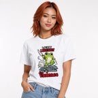 Model wearing a white T-shirt with a cute green frog holding a knife above stylised waves, with bold humorous text.