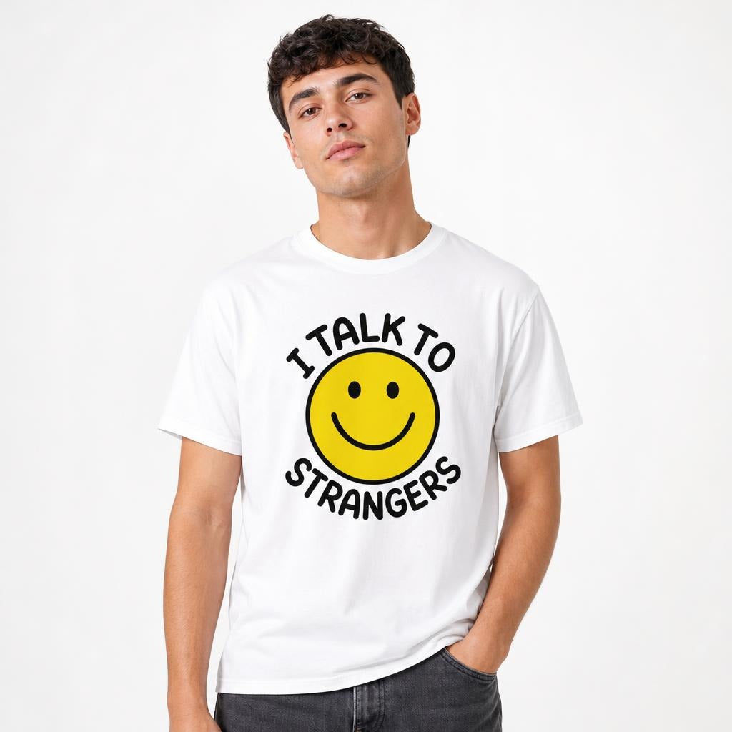 Model wearing a white T-shirt with a yellow smiley face and black “I TALK TO STRANGERS” graphic text.