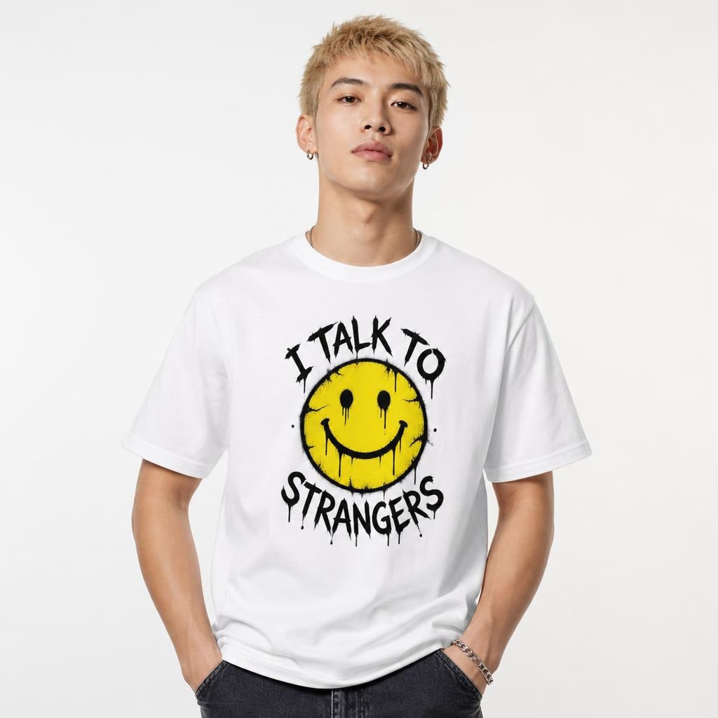 Model wearing a white T-shirt with a distressed yellow smiley face, dripping black eyes, wide grin, and “I TALK TO STRANGERS” text.