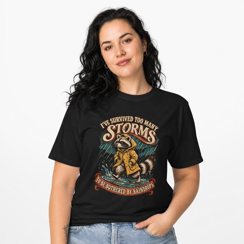 I Ve Survived Too Many Storms Funny Raccoon t shirt in Black worn by a studio model in an upper-body front relaxed pose on a clean white background