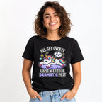 A colourful cartoon unicorn rests on a purple cloud with a sleeping thought bubble and stars on a black T-shirt.