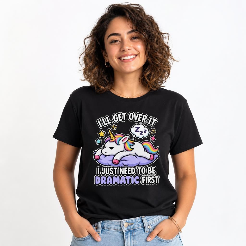 A colourful cartoon unicorn rests on a purple cloud with a sleeping thought bubble and stars on a black T-shirt.