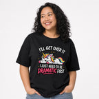Model wearing a Black T-shirt featuring a colourful cartoon unicorn, rainbow mane and tail, sparkles, and dramatic lettering.