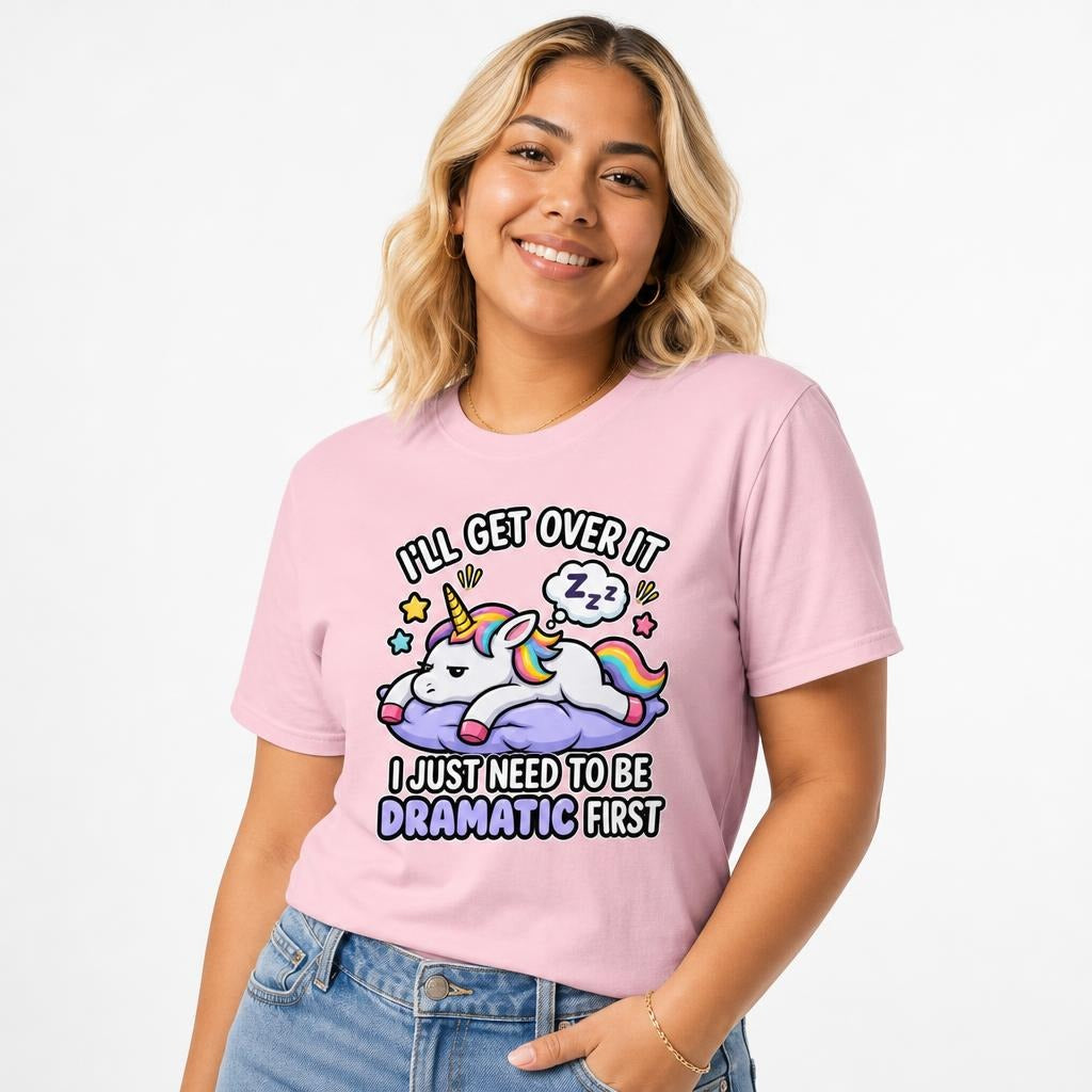 Model wearing a Blossom T-shirt with a colourful cartoon unicorn resting on a purple cloud beneath a sleeping thought bubble.