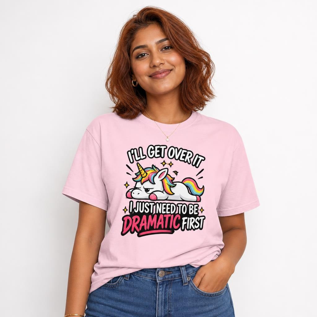 Front view of a model wearing a Blossom T-shirt with a colourful cartoon unicorn, rainbow mane and tail, sparkles, and bold lettering.