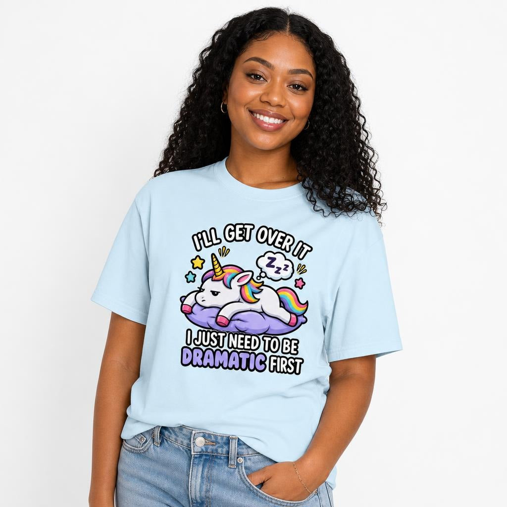 Chambray T-shirt featuring a colourful cartoon unicorn resting on a purple cloud with stars, rainbow mane and sleeping thought bubble.