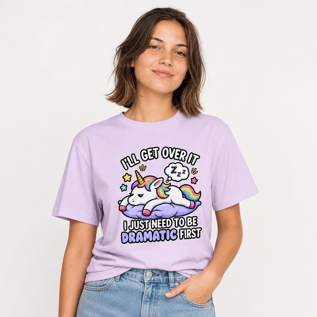 Model wearing an Orchid T-shirt with a colourful cartoon unicorn resting on a purple cloud beneath a sleeping thought bubble.