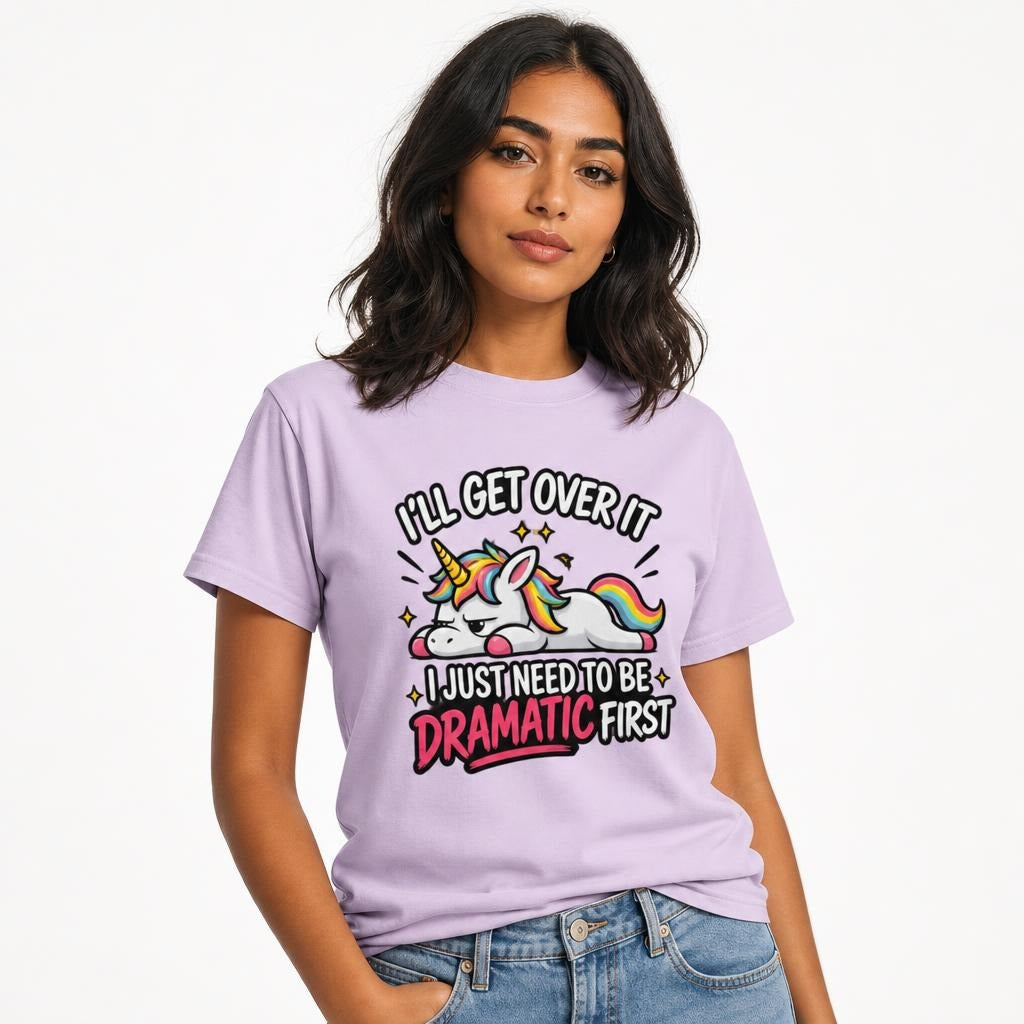 Model wearing an Orchid T-shirt with a colourful cartoon unicorn, rainbow mane and tail, sparkles, and dramatic lettering.