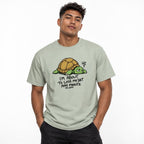 Model wearing a Bay T-shirt featuring a tired, sleepy-eyed cartoon turtle with a brown shell, green body, stress mark, and bold text.