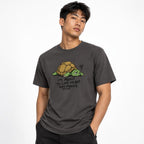 Front view of a Graphite T-shirt featuring a tired cartoon turtle and the text “I’M ABOUT TO LOSE MY SHIT ANY MINUTE.”