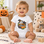 Baby wearing a white short-sleeve bodysuit with “My 1st Halloween” text, an orange pumpkin, black cat, bat, leaves and vines.