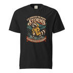 A black T-shirt features a raccoon in a yellow raincoat beneath the words “I’ve survived too many storms” and “to be bothered by raindrops.”