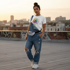 Latina woman wearing a white autism awareness rainbow sunflower t-shirt.
