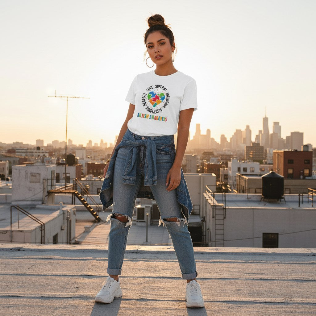Latina woman wearing a white autism awareness puzzle heart t-shirt.