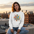 Latina woman wearing a white autism awareness puzzle sweatshirt.
