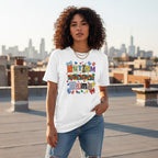 Latina woman wearing a white autism mama collage T-shirt.