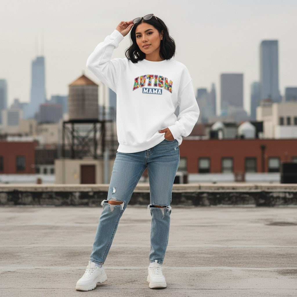 Latina woman wearing a white Autism Mama collegiate sweatshirt.