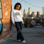 Latina woman wearing a white Autism Mama sweatshirt.