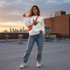 Latina woman wearing a white be kind autism awareness sweatshirt.