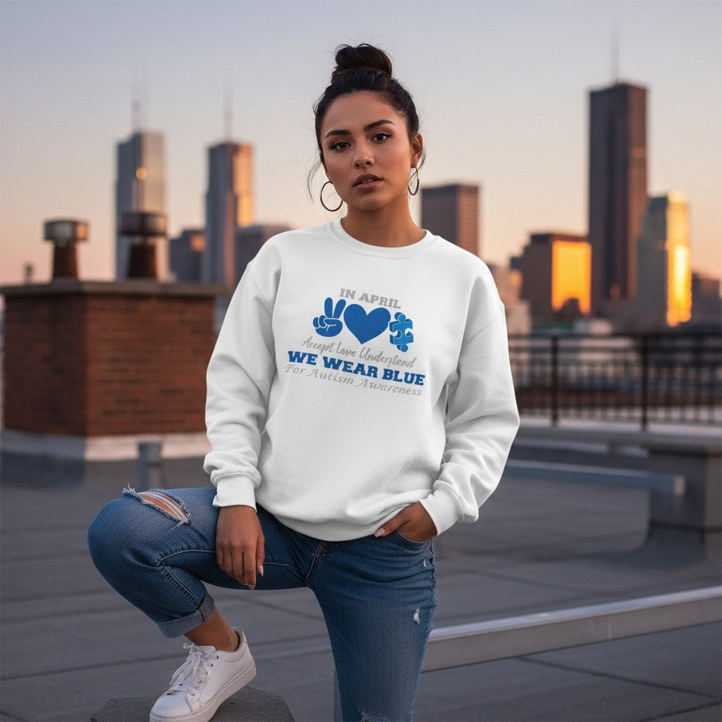 Latina woman wearing a white In April We Wear Blue autism awareness sweatshirt.