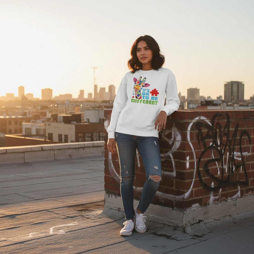 Latina woman wearing a white sweatshirt with a giraffe and "It's ok to be different" design.