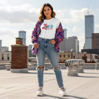 Latina woman wearing a white Love Needs No Words autism awareness t-shirt.