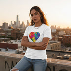Latina woman wearing a white autism awareness puzzle heart t-shirt.